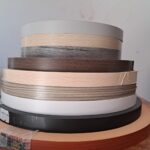 Multiple rolls of edge lipping in assorted colors and finishes, ideal for sealing board edges on custom furniture