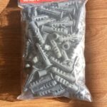 Pack of grey wall plugs for secure installation on concrete and drywall surfaces